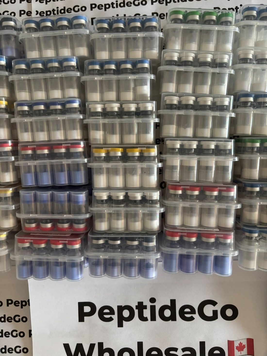 Bulk PeptideGo vial inventory stacked for wholesale fulfillment